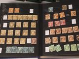 an open book with stamps on it sitting on a table