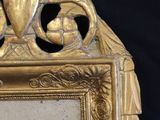 a gold frame with a picture of a man and a woman on it