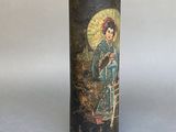 a black vase with a picture of a woman on it