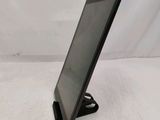 a tablet that is sitting on a stand on a table
