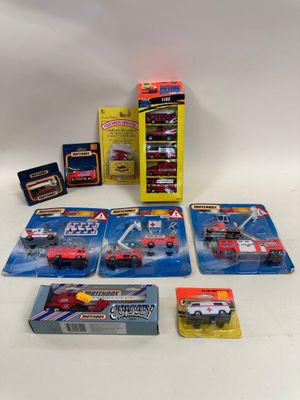 five cars and a box of other toys on the table