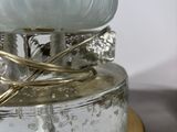 a glass lamp that is sitting on top of a table