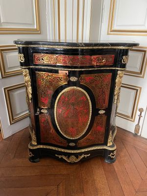 a black and gold cabinet with a red and gold decoration