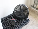 a fan that is sitting on top of a plastic crate
