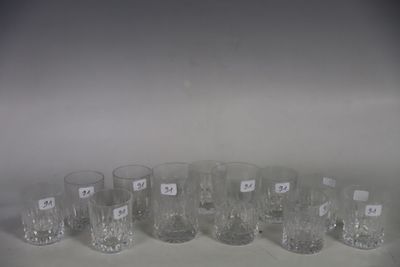six clear glasses are lined up in a row on a white surface