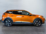 the orange nissan c - hr suv is parked in a showroom