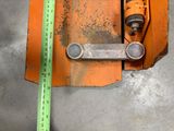a measuring tape on the floor next to a piece of metal