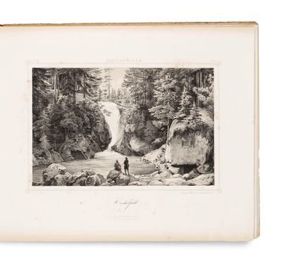 an old black and white photo of a man standing in front of a waterfall