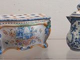 two vases that are on display on a table