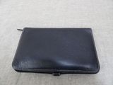 leather wallet with zipper on the inside of it sitting on a table