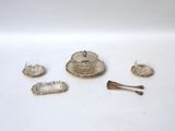 several pieces of silver on a white surface with a spoon, spoon and spoon rest