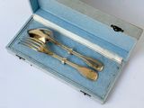 a silverware set in a blue box on a white surface