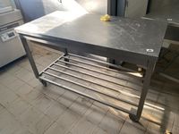 Une table rectangulaire en inox à claies d'entrejambe, sur r…