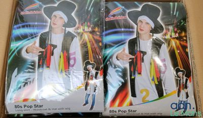 two boxes with two costumes of a man in a pirate hat and a woman in a pirate costume