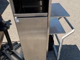 a metal cart that has a small oven on it