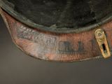 a close up of a hat on a wooden stand
