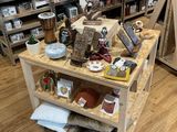 a wooden table with various items on it in a store