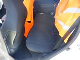 two seats in the back of a car with a safety vest on