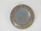 a blue plate with a brown rim sitting on a white surface