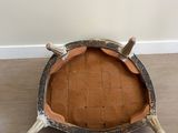 an old wooden bowl with a wooden handle sitting on top of a rug