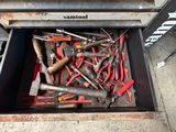 a man standing in front of a tool drawer full of tools