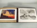 an open book with a picture of a volcano and a picture of a boat