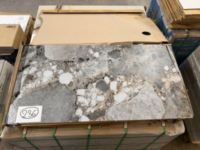 many boxes of marble on a pallet in a warehouse
