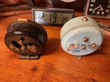 two clocks that are sitting on a wooden table