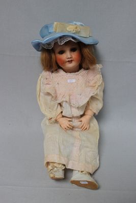 a doll that is sitting on the floor with a hat on