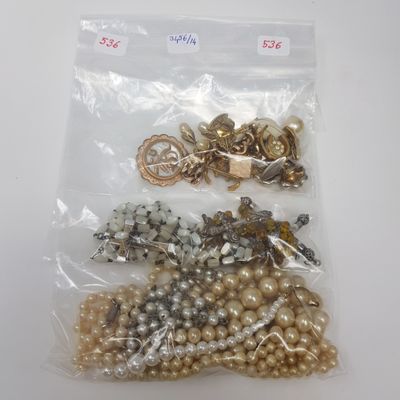 a bag of pearls and other jewelry on a table