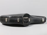 an old black guitar case sitting on top of a white table