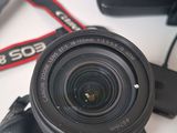 a close up of a camera with a camera strap and a camera bag