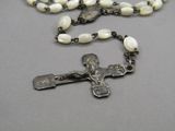 a rosary with a crucif on it on a table