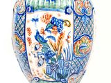 a blue and white vase sitting on a white surface