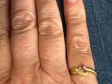 a woman ' s hand with a gold ring on it