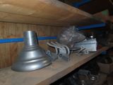 a metal lamp on a wooden shelf in a room