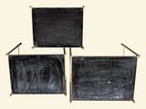 two black chairs sitting next to each other on a white surface