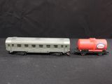 two toy trains sitting next to each other on a table