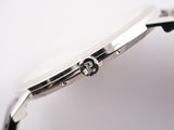 a close up of a watch on a white surface with a black strap