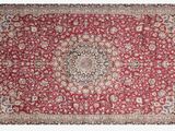 a red rug with a medallion design on it