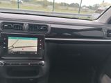 the dashboard of a car with a view of a plane on the screen