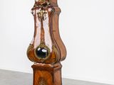 a grandfather clock that is standing in the middle of a room