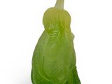 a glass figurine of a woman in a green dress