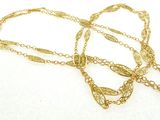 gold plated chain with a leaf pendant on a white background