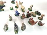 many figurines of different animals on a white surface