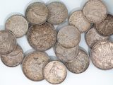 a pile of old coins on a white surface