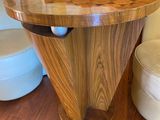 a wooden table with a glass on it in front of a fire place