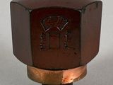 a close up of a brown knob on a white surface