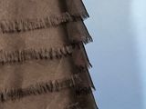 a close up of a dress with fringes on it