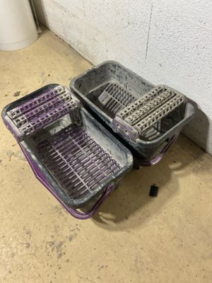 two baskets that are sitting on the floor next to each other